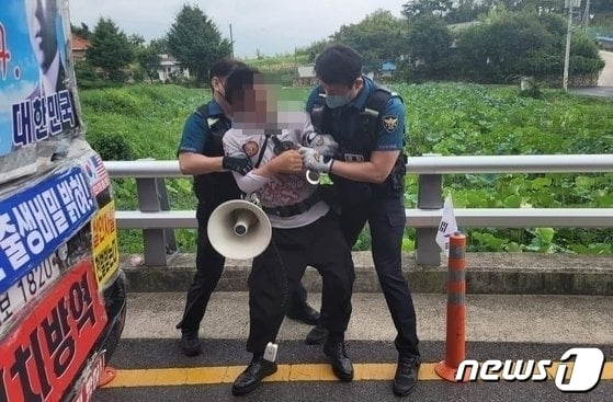 16일 문재인 전 대통령 사저가 있는 양산 하북면 평산마을 앞 도로에서 흉기를 휘두른 60대 남성이 경찰에 체포되고 있다. (독자 제공) /뉴스1