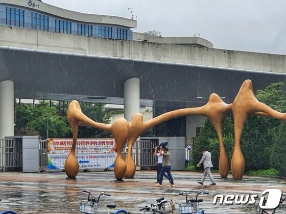 30일 오후 세종 정부세종청사 출입구에 우산없는 시민들이 갑자기 굵어진 빗줄기에 머리를 가리고 달리고 있다. 2022.8.30/뉴스1 © News1 황덕현 기자