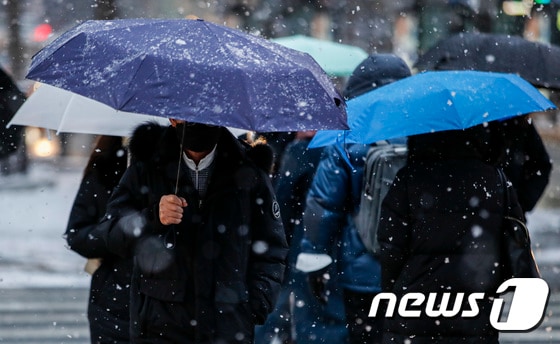 서울 세종대로사거리에서 우산을 쓴 시민들이 출근길 발걸음을 재촉하고 있다. 2023.1.26/뉴스1 © News1 김도우 기자