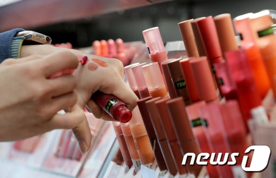 서울 종로구에 위치한 올리브영 매장을 찾은 시민이 색조 화장품을 직접 피부에 바르며 비교하고 있다.2023.1.29/뉴스1 © News1 장수영 기자