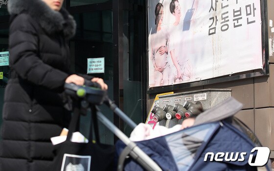 23일 오후 서울 시내의 한 산부인과 앞을 시민이 유모차에 유아를 태우고 지나는 지나고 있다. 2023.2.23/뉴스1 © News1 임세영 기자