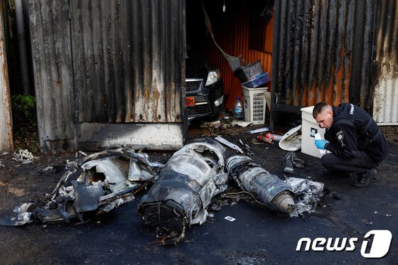 18일(현지시간) 우크라이나 전역에 공습 경보가 선포된 가운데 수도 키이우에서 경찰이 격추된 미사일을 살펴보고 있다. 23.05.18 © 로이터=뉴스1 © News1 김예슬 기자